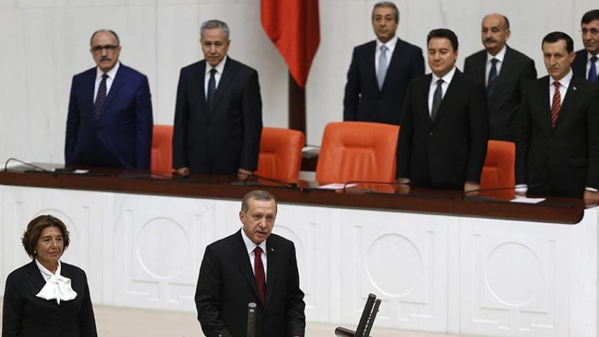 Turkey's new President Tayyip Erdogan (front C) attends a swearing in ceremony at the parliament in Ankara August 28, 2014. Erdogan was sworn in as Turkey's 12th president at a ceremony in parliament on Thursday, cementing his position as the country's most powerful modern leader, in what his opponents fear will herald an increasingly authoritarian rule.  REUTERS/Umit Bektas (TURKEY - Tags: POLITICS TPX IMAGES OF THE DAY) - RTR4437V