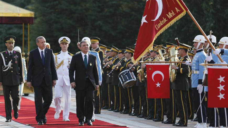 Turkey's new President Tayyip Erdogan (2nd L) and outgoing President Abdullah Gul (R), attend a handover ceremony at the Presidential Palace of Cankaya in Ankara August 28, 2014. Erdogan was sworn in as Turkey's 12th president at a ceremony in parliament on Thursday, cementing his position as the country's most powerful modern leader, in what his opponents fear will herald an increasingly authoritarian rule. REUTERS/Umit Bektas (TURKEY - Tags: POLITICS) - RTR444TR