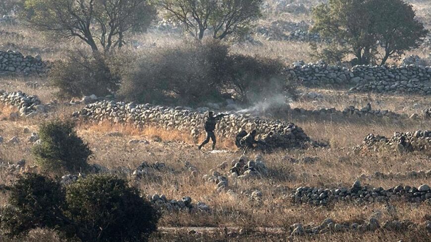 Syrian army soldiers fire during a battle in Syria with rebels near the border fence with the Israeli-occupied Golan Heights September 1, 2014. Heavy fighting between Syrian army forces and rebels erupted on the Golan Heights on Monday, a Reuters photographer said, but it was unclear if either of the two sides had gained an advantage to control a key frontier crossing. REUTERS/Baz Ratner (SYRIA - Tags: CIVIL UNREST POLITICS MILITARY TPX IMAGES OF THE DAY) - RTR44GUY