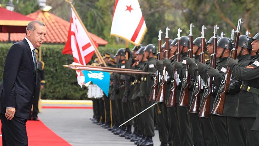 Turkey's President Tayyip Erdogan inspects the honour guard during a visit to Northern Cyprus September 1, 2014. Erdogan paid his first visit abroad as head of state to Northern Cyprus on Monday and said the window of opportunity will not remain open forever for a "two state solution" in the country. REUTERS/Andreas Manolis (CYPRUS - Tags: POLITICS) - RTR44JWG