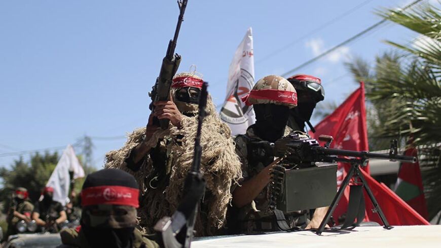 Palestinian militants from the Popular Front for the Liberation of Palestinian (PFLP) take part in a military show in Gaza City September 2, 2014. An open-ended ceasefire between Israel and Hamas-led Gaza militants, mediated by Egypt, took effect on August 26 after a seven-week conflict. It called for an indefinite halt to hostilities, the immediate opening of Gaza's blockaded crossings with Israel and Egypt, and a widening of the territory's fishing zone in the Mediterranean. 
REUTERS/Mohammed Salem (GAZA 