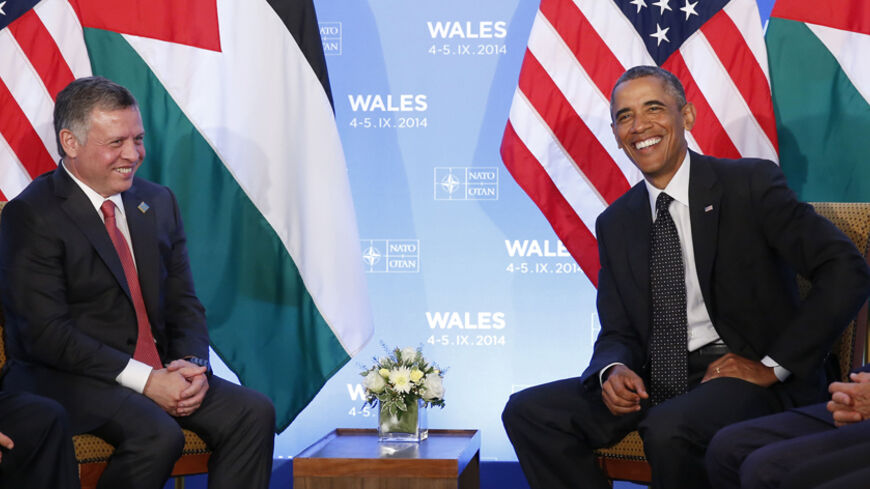 U.S. President Barack Obama (R) and Jordan's King Abdullah II smile during a meeting at the NATO Summit at the Celtic Manor Resort in Newport, Wales, September 4, 2014. REUTERS/Larry Downing (BRITAIN - Tags: POLITICS MILITARY) - RTR44YI4