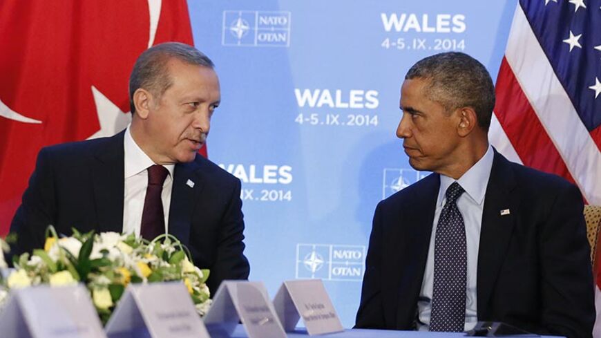 U.S. President Barack Obama listens as he hosts a bilateral meeting with Turkey's President Tayyip Erdogan during the NATO Summit at the Celtic Manor Resort in Newport, Wales September 5, 2014.      REUTERS/Larry Downing   (UNITED KINGDOM - Tags: POLITICS) - RTR453P4