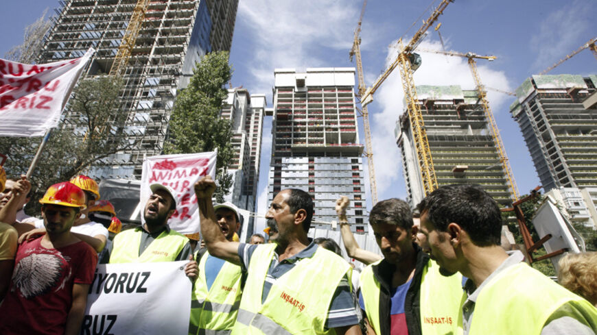 Workers shout slogans during a protest in front of an residential project, where an accident occurred in Istanbul September 8, 2014. Turkish real-estate developer Torunlar REIT said on Monday it has halted construction activities at all of its projects for five days following an accident that killed 10 workers at an Istanbul residential project. Work on the residential project, where the accident occurred at the weekend, has been suspended indefinitely and a legal investigation has been launched there, acco