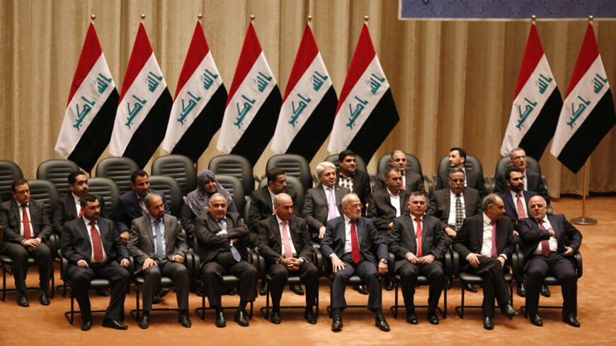 Members of the new Iraqi cabinet attend a parliamentary session to vote on Iraq's new government at the parliament headquarters in Baghdad, Iraq, September 8, 2014. Iraq's parliament approved a new government headed by Haider al-Abadi as prime minister on Monday night, in a bid to rescue Iraq from collapse, with sectarianism and Arab-Kurdish tensions on the rise. Picture taken September 8, 2014.  REUTERS/Thaier Al-Sudani (IRAQ - Tags: CIVIL UNREST POLITICS ELECTIONS) - RTR45I2V