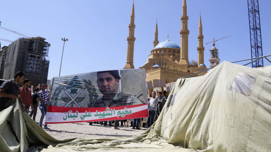 Relatives of Lebanese soldiers and policemen, who were captured by Islamist militants in Arsal, erect a tent and hold a banner depicting Lebanese soldier Ali al-Sayyed, who was beheaded by IS militants, during an open-ended sit-in demanding for the release of the remaining soldiers and pressuring the government to act in Martyrs' Square in downtown Beirut September 10, 2014. Islamic State militants have beheaded a captive Lebanese soldier, images published on social media showed on Saturday, the second Leba