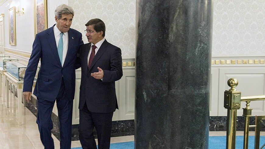 Turkey's Prime Minister Ahmet Davutoglu (R) walks with U.S. Secretary of State John Kerry at the prime minister's office in Ankara September 12, 2014. Kerry met Turkish leaders on Friday to try to win support for U.S.-led military action against Islamic State, but Ankara's reluctance to play a frontline role showed the difficulty of building a coalition for a regional war. REUTERS/Brendan Smialowski/Pool (TURKEY - Tags: POLITICS) - RTR460SV