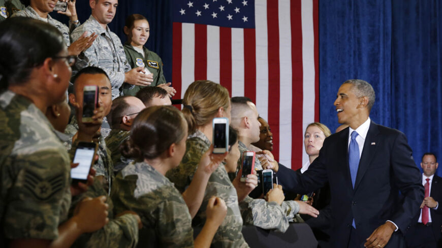 U.S. President Barack Obama shakes hands before speaking after a military briefing at U.S. Central Command at MacDill Air Force Base in Tampa, Florida, September 17, 2014.      REUTERS/Larry Downing   (UNITED STATES - Tags: POLITICS MILITARY) - RTR46M8H