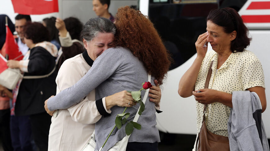 An employee (C) at Turkey's consulate in Mosul is welcomed by her relatives at Esenboga airport in Ankara September 20, 2014. Turkish intelligence agents brought 46 hostages seized by Islamic State militants in northern Iraq back to Turkey on Saturday after more than three months in captivity, in what Turkish President Tayyip Erdogan described as a covert rescue operation. Security sources told Reuters the hostages had been released overnight in the town of Tel Abyad on the Syrian side of the border with Tu