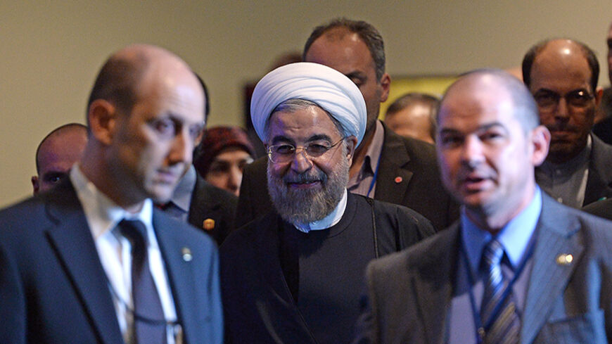 Iran's President Hassan Rouhani (C) is escorted for a meeting with U.N. Secretary-General Ban Ki-moon on the sidelines of the U.N. General Assembly in New York September 23, 2014. REUTERS/Jewel Samad/Pool (UNITED STATES - Tags: POLITICS ENVIRONMENT) - RTR47FN8