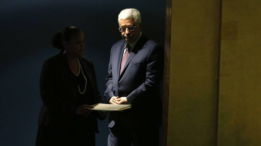 Palestinian President Mahmoud Abbas is escorted to the podium for his address to the 69th United Nations General Assembly at United Nations Headquarters in New York, September 26, 2014.  REUTERS/Mike Segar   (UNITED STATES - Tags: POLITICS) - RTR47UJL