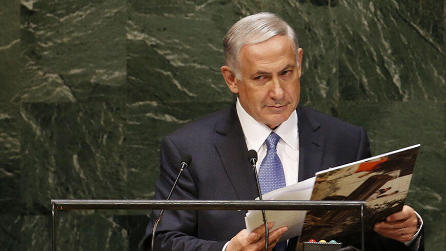 Israel's Prime Minister Benjamin Netanyahu gathers materials as he concludes his address to the 69th United Nations General Assembly at the U.N. headquarters in New York September 29, 2014.  REUTERS/Mike Segar   (UNITED STATES - Tags: POLITICS) - RTR487Y0