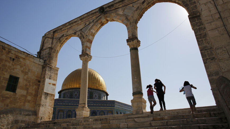 Palestinian girls walk up stairs near the Dome of the Rock (L) on a compound revered by Jews as the Temple Mount and by Muslims as the Noble Sanctuary, in Jerusalem's Old City June 23, 2013. Far-right Israelis have stepped up efforts to hold Jewish prayers at the Jerusalem holy compound once dominated by Biblical temples and now home to al-Aqsa mosque, one of Islam's most revered sites. Picture taken June 23, 2013. REUTERS/Darren Whiteside (JERUSALEM - Tags: RELIGION CIVIL UNREST) - RTX10ZBH