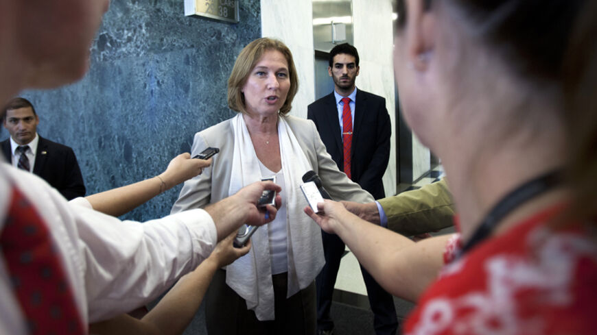 Israeli Justice Minister Tzipi Livni (C) talks to reporters in the lobby of the United Nations after her meeting with U.N. Secretary-General Ban Ki-moon (unseen) in New York, July 29, 2013. Livni is enroute to Washington for peace talks with the Palestinians.  REUTERS/Carlo Allegri  (UNITED STATES - Tags: POLITICS CIVIL UNREST) - RTX123XS