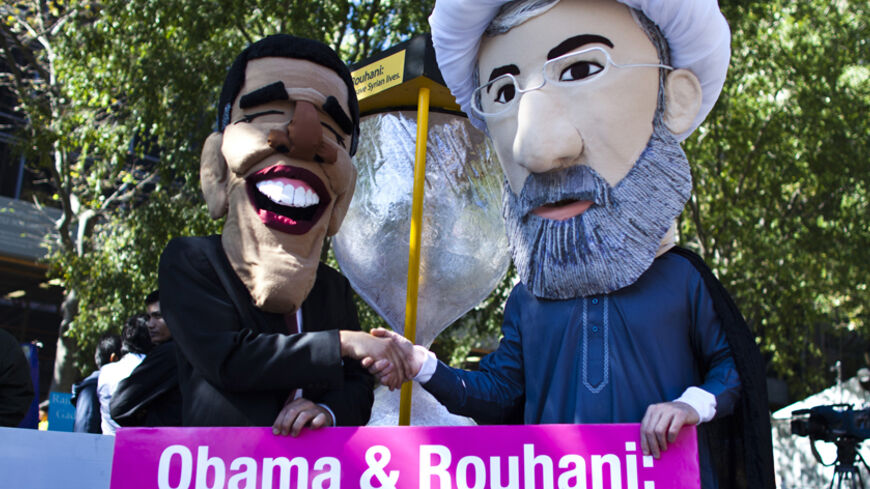 Members of international advocacy group Avaaz take part in a protest wearing masks of Iran's new President Hassan Rouhani (R) and U.S. president Barack Obama, outside the U.N. headquarters in New York September 24, 2013. REUTERS/Eduardo Munoz (UNITED STATES - Tags: POLITICS CIVIL UNREST) - RTX13Y0V