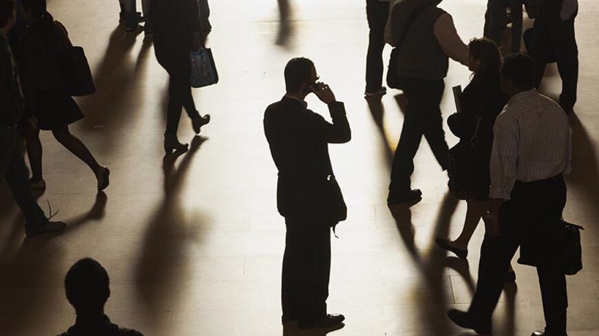 A man stands in the middle of Grand Central Terminal as he speaks on a cell phone, as passengers face limited train service on the New Haven Line between Stamford Station and Grand Central Terminal due to a Con Edison power problem in New York, September 25, 2013. REUTERS/Zoran Milich (UNITED STATES - Tags: TRANSPORT ENERGY TPX IMAGES OF THE DAY) - RTX13Z4Q