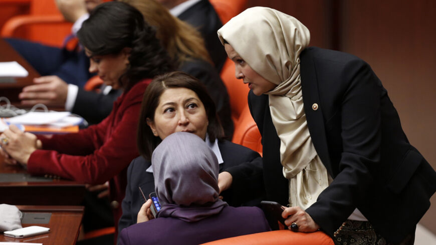 Turkey's ruling AK Party (AKP) lawmakers Nurcan Dalbudak (R) and Sevde Beyazit Kacar (front, seated) attend the general assembly wearing their headscarves at the Turkish Parliament in Ankara October 31, 2013. Four female lawmakers from Turkey's Islamist-rooted ruling party wore their Islamic head scarves in parliament on Thursday in a challenge to the country's secular tradition. Four female lawmakers, Nurcan Dalbudak, Sevde Beyazit Kacar, Gulay Samanci and Gonul Bekin Sahkulubey, from Turkey's Islamist-roo