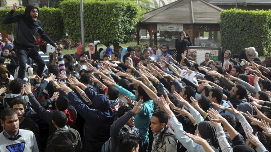 Cairo University students supporting the Muslim Brotherhood and deposed President Mohamed Mursi shout slogans at the university's campus in Cairo December 29, 2013. REUTERS/Stringer (EGYPT - Tags: POLITICS CIVIL UNREST EDUCATION) - RTX16X4K