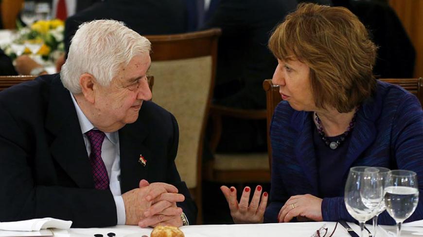 Syria's Foreign Minister Walid al-Moualem listens to EU foreign policy chief Catherine Ashton (R) as they wait for lunch during a break in the Geneva-2 peace talks in Montreux January 22, 2014. Syria's government and opposition, meeting for the first time, angrily spelled out their mutual hostility on Wednesday at a U.N. peace conference where world powers also offered sharply divergent views on forcing out Bashar al-Assad. REUTERS/Arnd Wiegmann (SWITZERLAND - Tags: CIVIL UNREST POLITICS CONFLICT) - RTX17PZ
