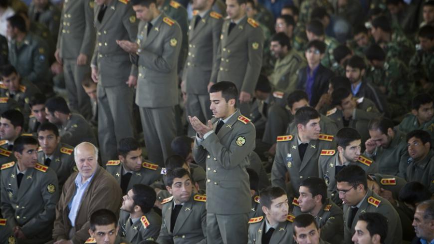 Members of the Iranian army pray at a university as they attend for Tehran's Friday prayers, April 10, 2009. Reform minded youth see America as the land of opportunity and would like to see ties with the U.S. restored but conservative minded youth see the U.S. as the enemy and feel that the Islamic Revolution?s goals must be kept alive.   REUTERS/Morteza Nikoubazl (IRAN) - RTXDXUQ