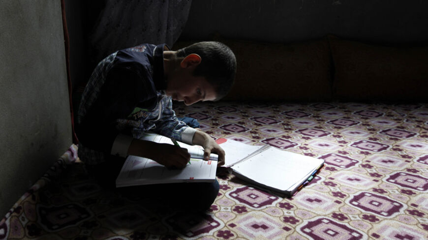 Ferhat Savun aged 11, works on his homework in his home in town of  Cizre in Sirnak province, near the border with Syria March 23, 2013. Turkey's fledgling peace process with the Kurdistan Workers Party (PKK) militant group is all over the headlines. After three decades of war, 40,000 deaths and a devastating impact on the local economy, everybody seems ready for peace. Pro-Kurdish politicians are focused on boosting minority rights and stronger local government for the Kurds, who make up about 20 percent o