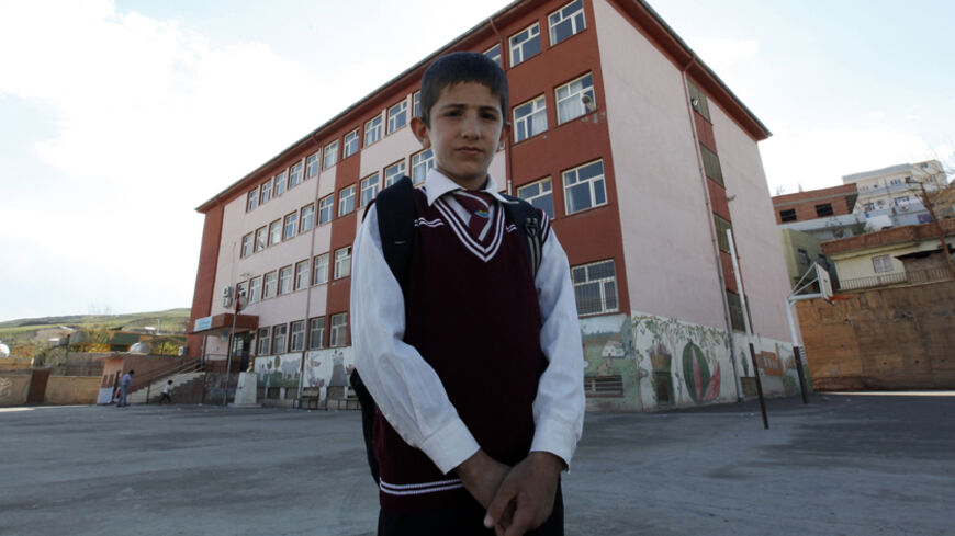 Ferhat Savun  aged 11, poses in front of his school in the town of Cizre in Sirnak province, near the border with Syria March 24, 2013. Turkey's fledgling peace process with the Kurdistan Workers Party (PKK) militant group is all over the headlines. After three decades of war, 40,000 deaths and a devastating impact on the local economy, everybody seems ready for peace. Pro-Kurdish politicians are focused on boosting minority rights and stronger local government for the Kurds, who make up about 20 percent of