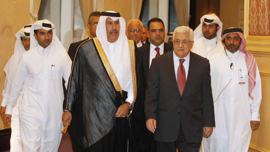 Palestinian President Mahmoud Abbas (front R) and Qatar's Prime Minister Hamad bin Jassim bin Jabr Al-Thani arrive at a meeting of the Arab Peace Initiative Committee in Doha April 8, 2013. REUTERS/Mohammed Dabbous (QATAR - Tags: POLITICS) - RTXYDPI