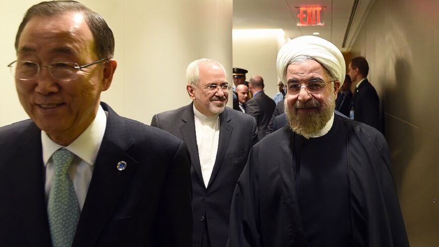 U.N. Secretary-General Ban Ki-moon (L) escorts Iran's President Hassan Rouhani for a meeting on the sidelines of the U.N. General Assembly in New York September 23, 2014. REUTERS/Jewel Samad/Pool (UNITED STATES - Tags: POLITICS ENVIRONMENT) - RTR47FMQ