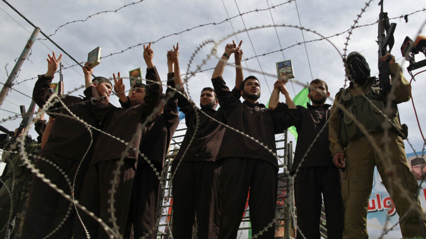 Hamas supporters acting as freed prisoners take part in a rally, calling for the release of Palestinian prisoners from Israeli jails, in Jabalya, in the northern Gaza Strip, April 13, 2012. REUTERS/Mohammed Salem (GAZA - Tags: POLITICS CIVIL UNREST) - RTR30OFL