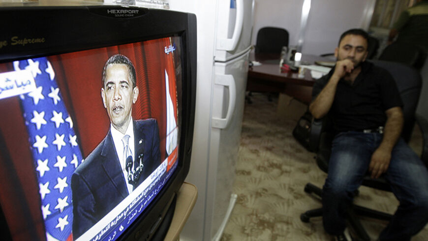 A resident watches a television broadcasting the speech of U.S. President Barack Obama, at the Culture Ministry in Baghdad June 4, 2009. Obama told the world's Muslims on Thursday that violent extremists had exploited tensions between Muslims and the West, and that Islam was not part of the problem but part of promoting peace. The speech, delivered from Cairo University in the centre of Egypt's sprawling capital, is aimed at healing a rift between Washington and the Islamic world.  REUTERS/Mohammed Ameen (I