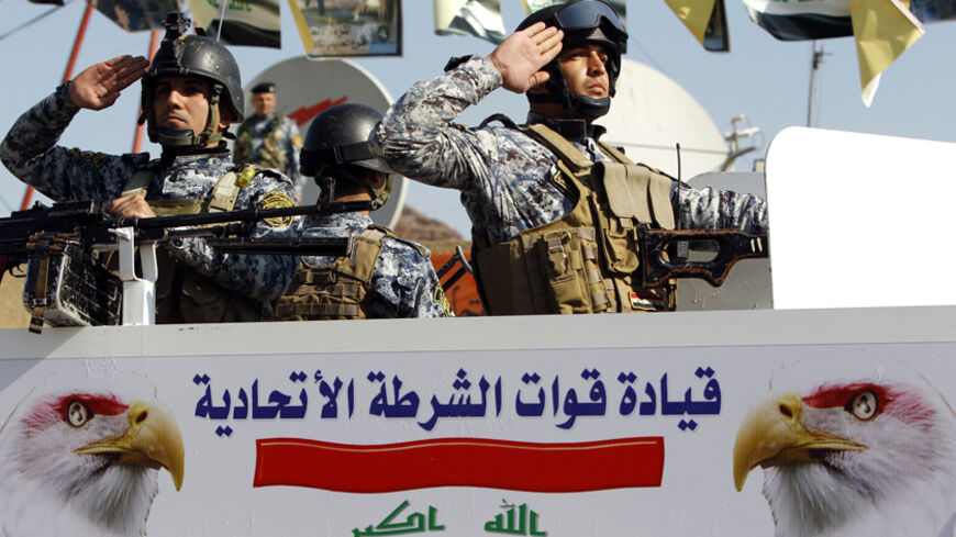 Iraqi federal police salute during the seventh anniversary of the founding of the federal police in Baghdad November 22, 2011. With U.S. troops scheduled to leave Iraq at the end of the year, Baghdad is looking to build its national armed forces to take over responsibility for security. REUTERS/Saad Shalash (IRAQ - Tags : - Tags: CONFLICT) - RTR2UBMY