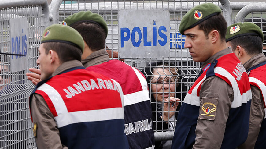 Gendarmes stand guard as visitors wait behind the security barriers outside the courthouse in Silivri near Istanbul March 11, 2013. The trial of nearly 300 people, who are charged with attempting to overthrow Prime Minister Tayyip Erdogan's Islamist-rooted government, resumed at Silivri prison complex. The case is emblematic of Erdogan's long-standing battle with secularist opponents, and one of a series of conspiracy trials that he describes as a struggle against anti-democratic forces.  REUTERS/Murad Seze