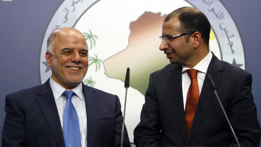 Salim al-Jabouri (R), new speaker of the Iraqi Council of Representatives, and Shi'ite deputy speaker Haider Abadi (L), a member of Iraqi Prime Minister Nuri al-Maliki's State of Law bloc, attend a news conference in Baghdad, July 15, 2014. Iraqi politicians named Jabouri, a moderate Sunni Islamist, as speaker of parliament on Tuesday, a long-delayed first step towards a power-sharing government urgently needed to save the state from disintegration in the face of a Sunni uprising. REUTERS/Ahmed Saad (IRAQ -