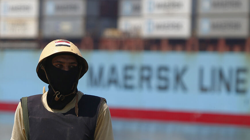A member of Egypt's army guards the Suez Canal in Ismailia port city, northeast of Cairo August 12, 2014. Egypt said last Tuesday it plans to build a new Suez Canal alongside the existing 145-year-old historic waterway in a multi-billion dollar project to expand trade along the fastest shipping route between Europe and Asia. Picture taken August 12, 2014.   REUTERS/Amr Abdallah Dalsh  (EGYPT - Tags: POLITICS MILITARY SOCIETY BUSINESS) - RTR429FY