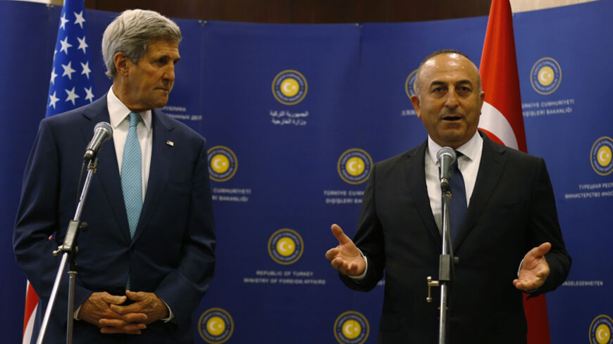 U.S. Secretary of State John Kerry (L) and Turkey's Foreign Minister Mevlut Cavusoglu talk to the media before a meeting in Ankara September 12, 2014. Kerry will meet Cavusoglu, as well as Prime Minister Ahmet Davutoglu and President Tayyip Erdogan during his two-day visit to the capital Ankara, the Turkish Foreign Ministry said. REUTERS/Umit Bektas (TURKEY - Tags: POLITICS) - RTR45Z12