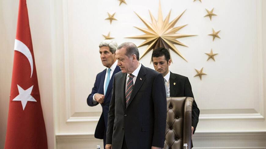 U.S. Secretary of State John Kerry (back) and Turkish President Recep Tayyip Erdogan (C) take their seats at the president's office during a meeting in Ankara on September 12, 2014. Kerry met Turkish leaders on Friday to try to win support for U.S.-led military action against Islamic State, but Ankara's reluctance to play a frontline role showed the difficulty of building a coalition for a regional war.   REUTERS/Brendan Smialowski/Pool (TURKEY - Tags: POLITICS) - RTR460SR
