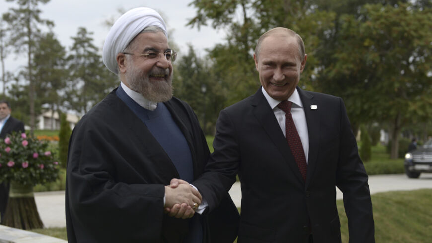 Russia's President Vladimir Putin (R) shakes hands with his Iranian counterpart Hassan Rouhani at the welcoming ceremony during a summit of Caspian Sea regional leaders in the southern city of Astrakhan, September 29, 2014. REUTERS/Alexei Nikolsky/RIA Novosti/Kremlin (RUSSIA - Tags: POLITICS) ATTENTION EDITORS - THIS IMAGE HAS BEEN SUPPLIED BY A THIRD PARTY. IT IS DISTRIBUTED, EXACTLY AS RECEIVED BY REUTERS, AS A SERVICE TO CLIENTS - RTR485US