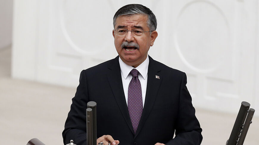 Turkey's Defence Minister Ismet Yilmaz speaks during a debate on a motion which would allow the government to authorise cross-border military incursions against Islamic State fighters in Syria and Iraq, and allow coalition forces to use Turkish territory, in Ankara October 2, 2014. REUTERS/Umit Bektas (TURKEY - Tags: POLITICS MILITARY CIVIL UNREST CONFLICT) - RTR48OTJ