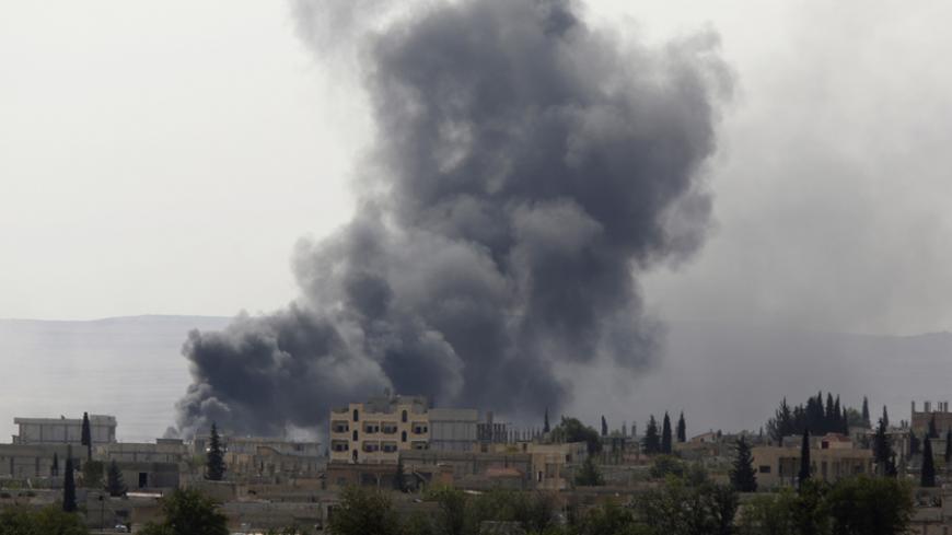 Smoke rises from the Syrian town of Kobani, seen from near the Mursitpinar border crossing on the Turkish-Syrian border in the southeastern town of Suruc, Sanliurfa province, October 3, 2014. Turkey will do what it can to prevent the predominantly Kurdish town of Kobani, near its border with Syria, falling to Islamic State insurgents, Prime Minister Ahmet Davutoglu said late on Thursday, but stopped short of committing to military action. Hours before Davutoglu's comments, parliament gave the government pow