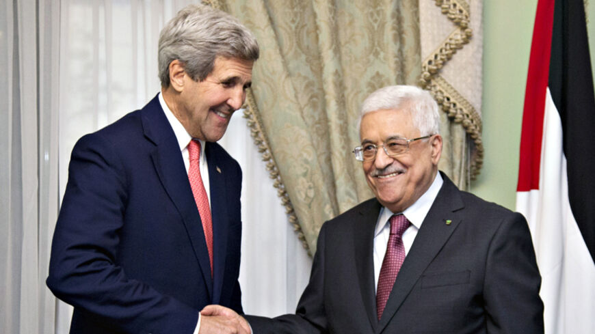 U.S. Secretary of State John Kerry shakes hands with Palestinian President Mahmoud Abbas (R) at Andalus Villa in Cairo October 12, 2014, on the sidelines of the Gaza Donor Conference. REUTERS/Carolyn Kaster/Pool (EGYPT - Tags: POLITICS) - RTR49VLY