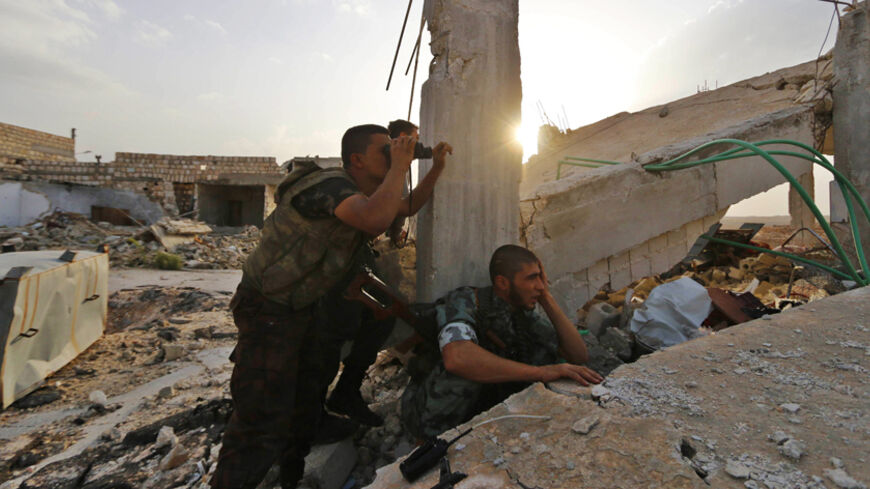Rebel fighters take positions during clashes with forces loyal to Syria's President Bashar al-Assad around Handarat area October 12, 2014. REUTERS/Hosam Katan  (SYRIA - Tags: POLITICS CIVIL UNREST CONFLICT) - RTR49VUO
