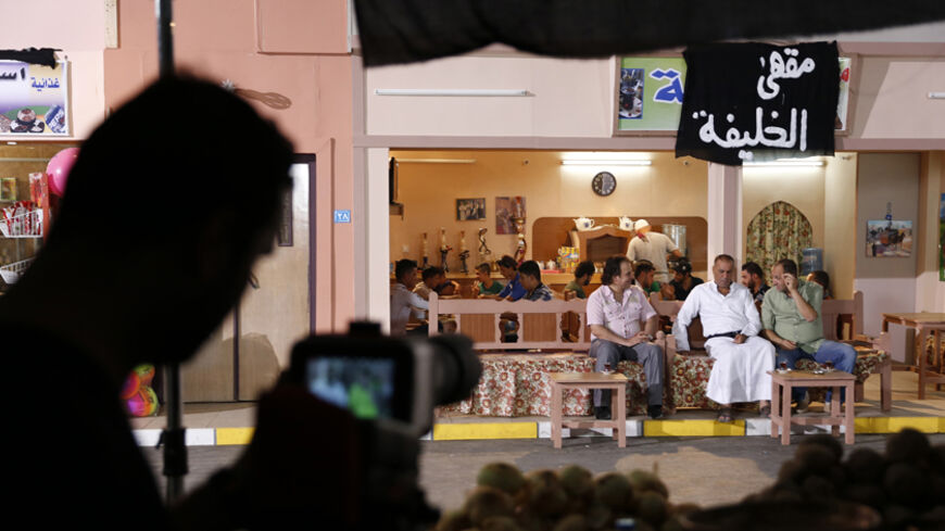 A view shows actors during the filming of the set of the television series, whose title is loosely translated as "State of Myths" in Baghdad October 10, 2014. Humour and silly puns are being used as the latest weapons in the fight against extreme militants who now control large swathes of Iraqi territories. Playing on the words Kalifa (Caliphate) and Kurafa (myths or superstitions), the new Iraqi comedy show 'Dawlat al-Khurafa' (State of Myths), began airing on Iraqi state television early this month. Pictu