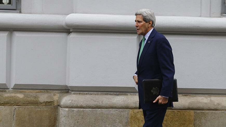 U.S. Secretary of State John Kerry arrives prior to a meeting with EU foreign policy chief Catherine Ashton and Iranian Foreign Minister Mohammad Javad Zarif, at a hotel in Vienna October 15, 2014. World powers and Iran are not discussing extending a late November deadline for reaching an accord over Tehran's nuclear programme, a senior U.S. official said on Wednesday, adding there was still time to strike a deal.     REUTERS/Leonhard Foeger (AUSTRIA  - Tags: POLITICS ENERGY)   - RTR4A9ED