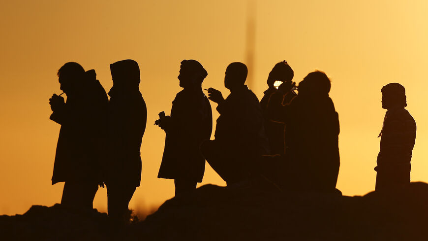 Turkish Kurds watch the Syrian town of Kobani from a hill near the Mursitpinar crossing, on the Turkish-Syrian border in the southeastern town of Suruc in Sanliurfa province October 20, 2014. Turkish Foreign Minister Mevlut Cavusoglu said on Monday that Turkey was facilitating the passage of Iraqi Kurdish peshmerga fighters to Kobani to aid Syrian Kurds defending the town against Islamic State militants.  REUTERS/Kai Pfaffenbach (TURKEY  - Tags: MILITARY CONFLICT POLITICS)   - RTR4AUOP