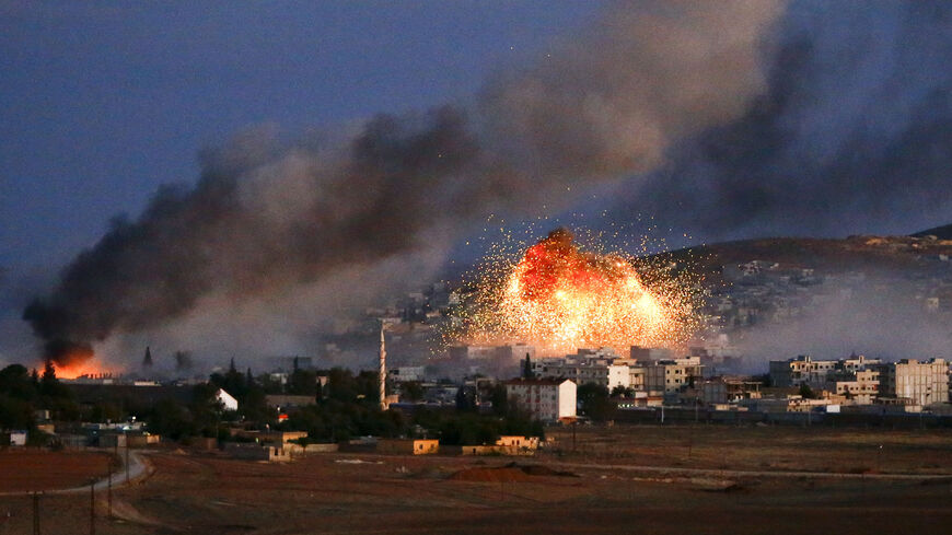 Smoke and flames rise over Syrian town of Kobani after an airstrike, as seen from the Mursitpinar crossing on the Turkish-Syrian border in the southeastern town of Suruc in Sanliurfa province, October 20, 2014. The United States told Turkey that a U.S. military air-drop of arms to Syrian Kurds battling Islamic State near the Syrian town of Kobani was a response to a crisis situation and did not represent a change in U.S. policy, U.S. Secretary of State John Kerry said on Monday.     REUTERS/Kai Pfaffenbach 