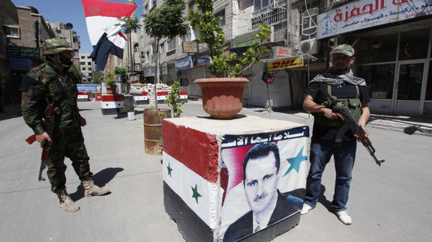 Security personnel loyal to Syria's President Bashar al-Assad stand guard at a checkpoint in Damascus May 27, 2013. Picture taken May 27, 2013.  REUTERS/ Alaa Al-Marjani (SYRIA - Tags: CIVIL UNREST POLITICS MILITARY CONFLICT) - RTX104TS