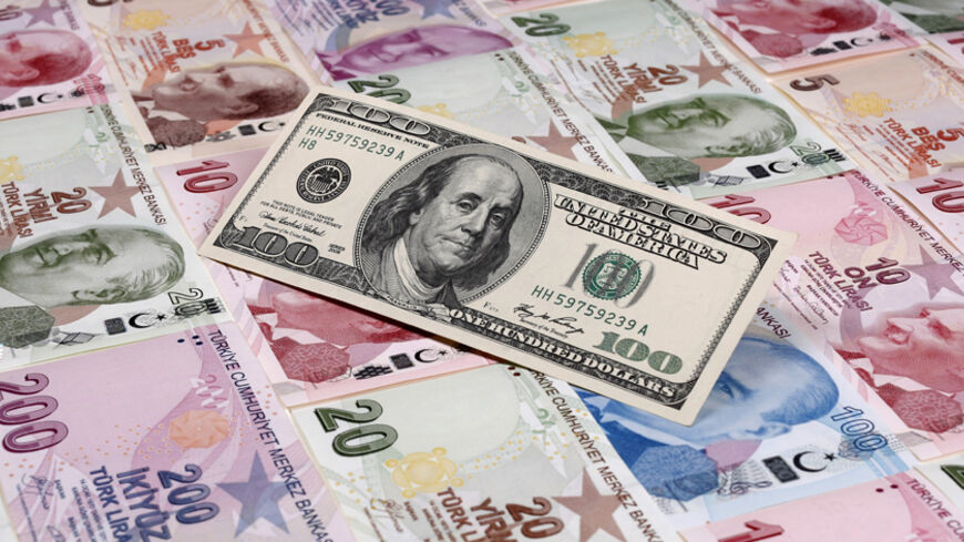 A photo illustration taken in Istanbul shows a U.S. 100 dollar banknote against Turkish lira banknotes of various denominations January 7, 2014. Turkey's lira slipped against the U.S. dollar on Wednesday as the government bond yield curve, which had briefly inverted on Tuesday because of speculation about an emergency rate hike to rescue the currency, returned to a positive slope. Picture taken January 7, 2014. REUTERS/Murad Sezer (TURKEY - Tags: BUSINESS) - RTX1761T