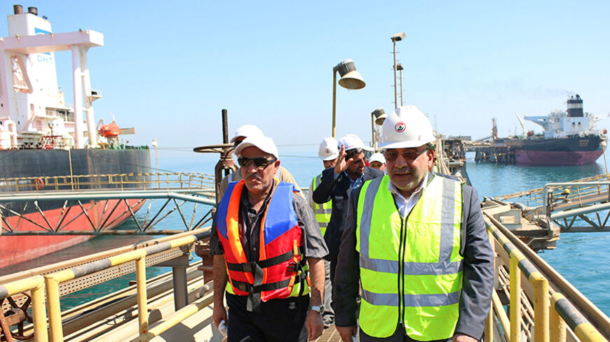 The Iraqi Minister of Oil Adel Abdel Mahdi (R) takes a tour  a floating platform for oil tankers on September 21, 2014, offshore from the southern Iraqi port city of Al Faw, 90 kilometres south of Basra.  An OPEC report on September 10, 2014 said that demand for oil would grow by 1.05 million barrels per day in 2014 to 91.2 million in 2015, trimming 50,000 barrels from the previous outlook. Demand in 2015 is expected to grow 1.19 million barrels per day, 20,000 barrels a day fewer than before, the cartel sa