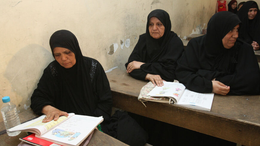 Iraqi women take part in a literacy class at a school in the Hay al-Amel neighborhood of Baghdad on September 9 2008. The classes under the umbrella 'Culture For All', are funded by several charity organizations based in London also by UNICEF and the Red Crescent. 'Culture for All'  runs several initiatives including teaching adult illiteracy classes and sewing classes, they also provide lawyers to advise citizens on human right issues. AFP PHOTO / ALI YUSSEF (Photo credit should read ALI YUSSEF/AFP/Getty I