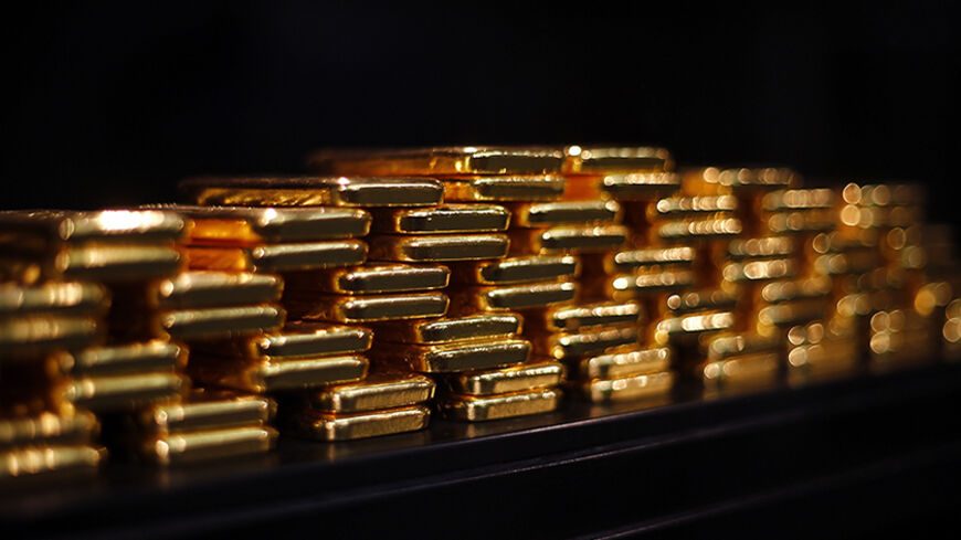 Gold bars are stacked at a safe deposit room of the ProAurum gold house in Munich March 6, 2014. Gold was flat on Thursday as diplomatic efforts to cool the Ukraine crisis depressed demand for assets seen as safe, but the metal found support above $1,330 an ounce from weak U.S. economic data and ahead of a key employment report.     REUTERS/Michael Dalder(GERMANY - Tags: BUSINESS COMMODITIES SOCIETY) - RTR3G4CM